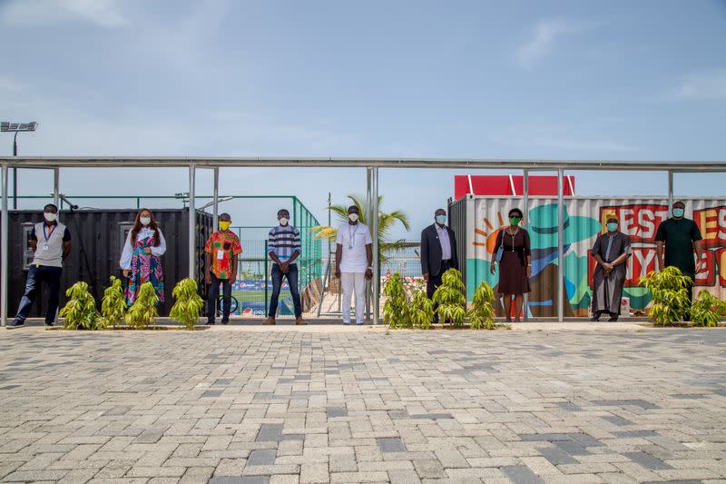 Staff of Arnergy Solar Limited and representatives of Lagos state government pose for a picture under solar panels at an isolation centre in Lagos