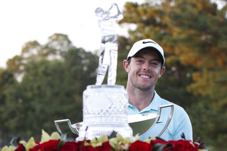 Sep 25, 2016; Atlanta, GA, USA; Rory McIlroy celebrates with the FedEx Cup trophy and the Tour Championship trophy after playing the Tour Championship at East Lake Golf Club. Mandatory Credit: Brett Davis-USA TODAY Sports