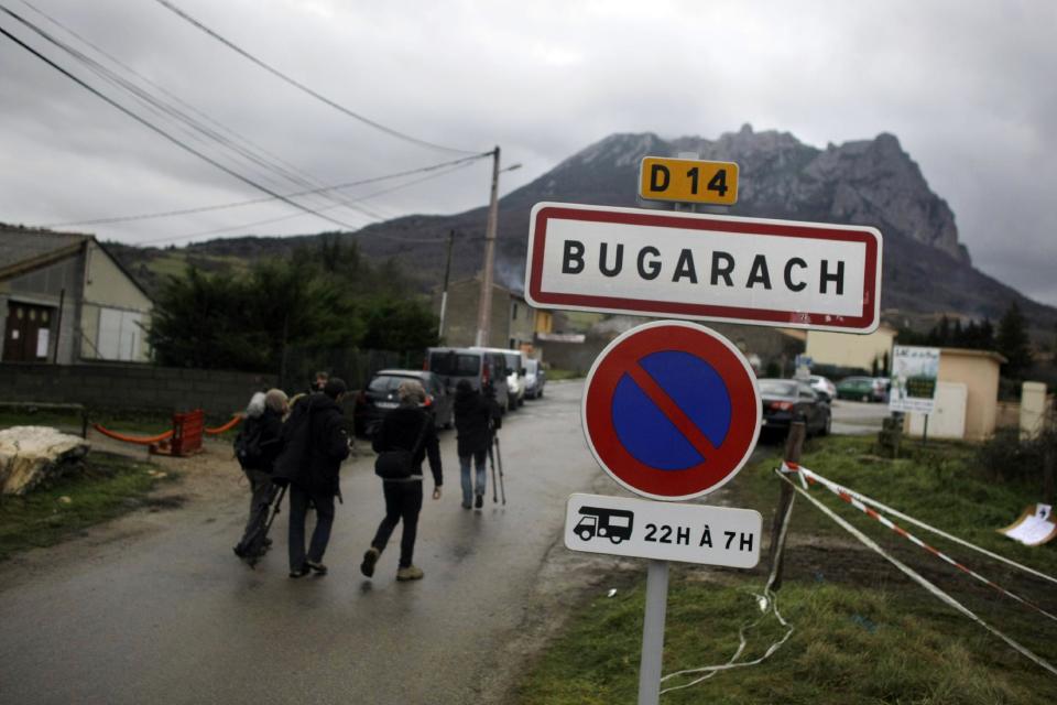 Pic de Bugarach mountain rises above the small town of Bugarach, France, Friday, Dec. 21, 2012. Although the long expected end of the Mayan calendar has come, the New Age enthusiasts have steered clear from the sleepy French town of Bugarach, which gave some locals a chance to joke about the end of the world legends that surround the area. (AP Photo/Marko Drobnjakovic)