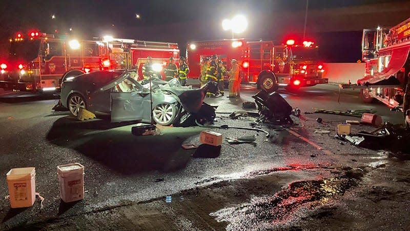 In this photo released by Contra Costa County Fire Protection District, firefighters work the scene of a fatal accident involving a Tesla and Contra Costa County fire truck early Saturday morning, Feb. 18, 2023, in Contra Costa, Calif.