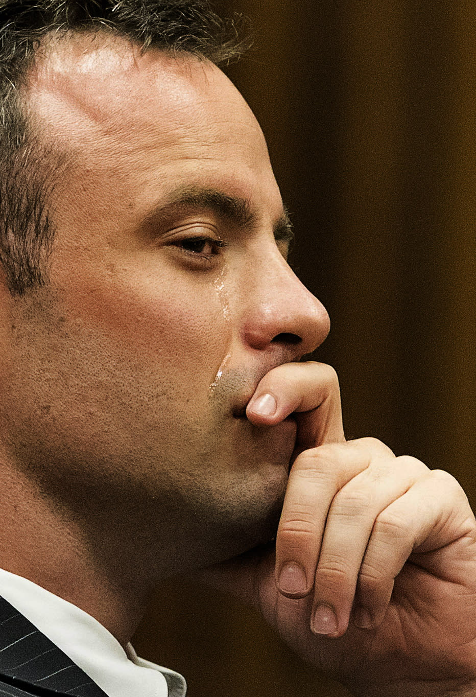 Oscar Pistorius, sheds a tear as he stares ahead during a cross examination of witnesses in court in Pretoria, South Africa, Tuesday, March 18, 2014. Pistorius is on trial for the murder of his girlfriend Reeva Steenkampon on Valentine's Day, 2013. (AP Photo/Marco Longari, Pool)