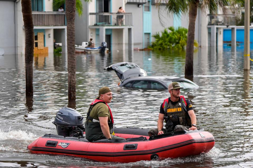 A water rescue boat moves in flood waters on Thursday morning in Clearwater, Florida. ((AP Photo/Mike Stewart))