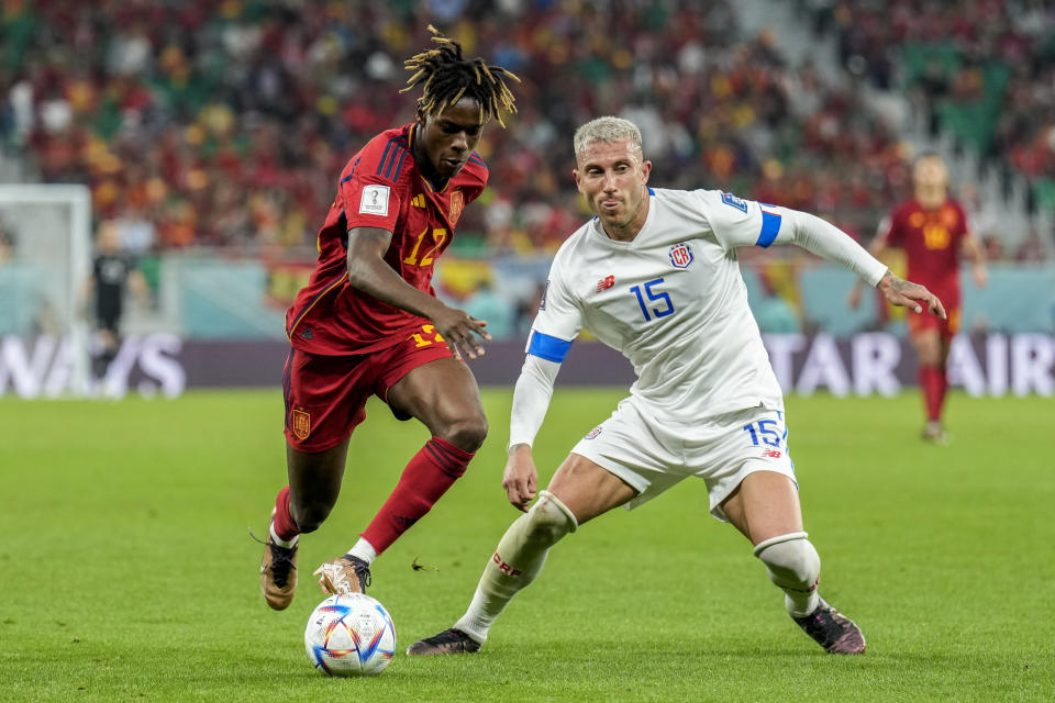 Spain's Nico Williams, left, vies for the ball with Costa Rica's Francisco Calvo during the World Cup group E soccer match between Spain and Costa Rica, at the Al Thumama Stadium in Doha, Qatar, Wednesday, Nov. 23, 2022. (AP Photo/Francisco Seco)