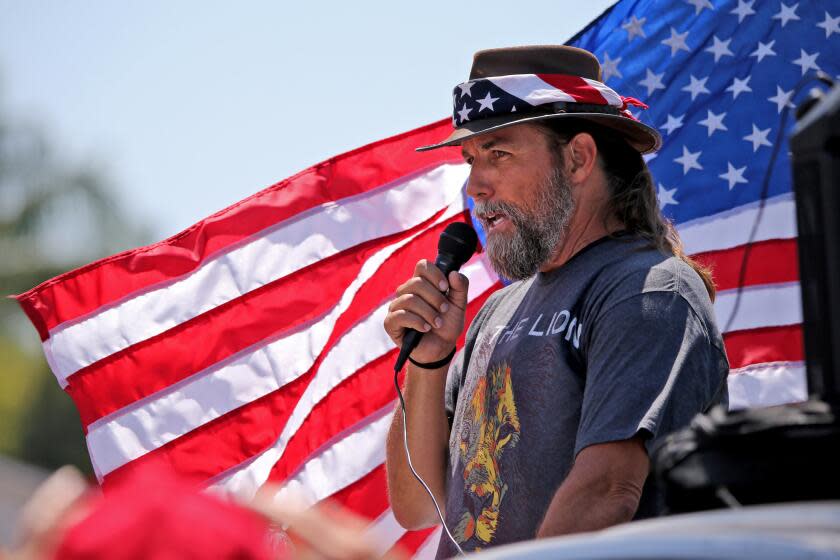 Organizer Alan Hostetter speaks to participants near Mother's Market and Kitchen during rally against mask orders implemented by the city of Costa Mesa that include a $100 fine if not wearing one in public, in Costa Mesa on Saturday, Aug. 15, 2020. About 150 people heard speakers for about an hour before heading to the corner of 19th St. and Newport Blvd., in Costa Mesa.