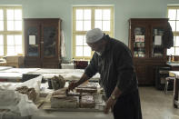 A conservator works at the National Museum of Afghanistan, in Kabul, Monday, Dec. 6, 2021. The National Museum of Afghanistan is open once again -- and the Taliban, whose members once smashed their way through the facility, destroying irreplaceable pieces of Afghanistan's national heritage, now appear to be among its most enthusiastic visitors. (AP Photo/Petros Giannakouris)