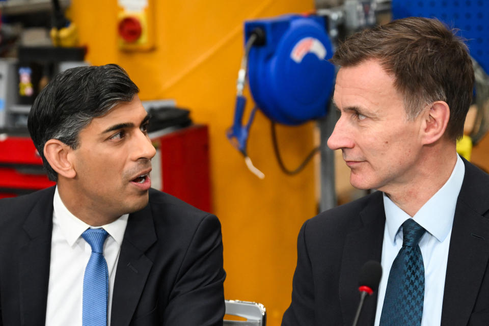 Britain's Prime Minister Rishi Sunak (L) and Britain's Chancellor of the Exchequer Jeremy Hunt speak during a cabinet meeting  at the Siemens Mobility factory, in Goole, in East Yorkshire, on February 26, 2024. (Photo by Paul ELLIS / POOL / AFP) (Photo by PAUL ELLIS/POOL/AFP via Getty Images)