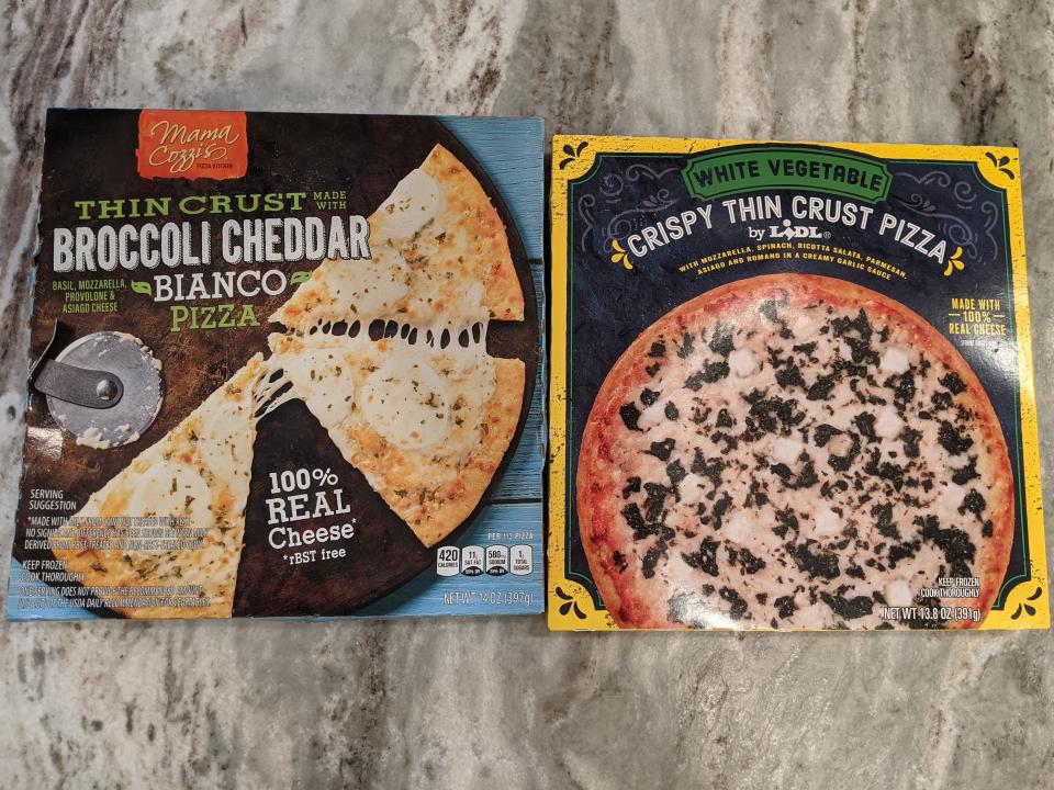 aldi and lidl's white pizzas on boxes next to each other