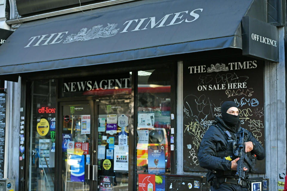 A member of the police, outside a newsagent, in the vicinity of Borough Market and London Bridge.