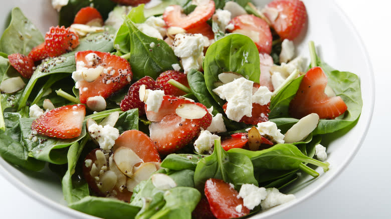 spinach leaves with strawberries and cheese