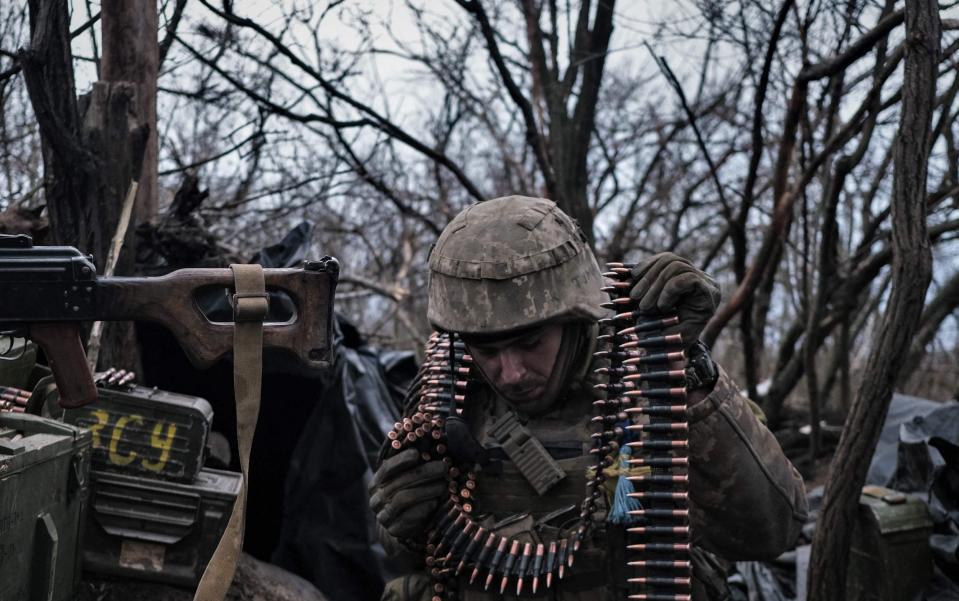A soldier of the Ukrainian Volunteer Army prepares ammunition to fire at Russian front line positions near Bakhmut, Donetsk region, on March 11, 2023, amid the Russian invasion of Ukraine. (Photo by Sergey SHESTAK / AFP) (Photo by SERGEY SHESTAK/AFP via Getty Images) - SERGEY SHESTAK/AFP via Getty Images