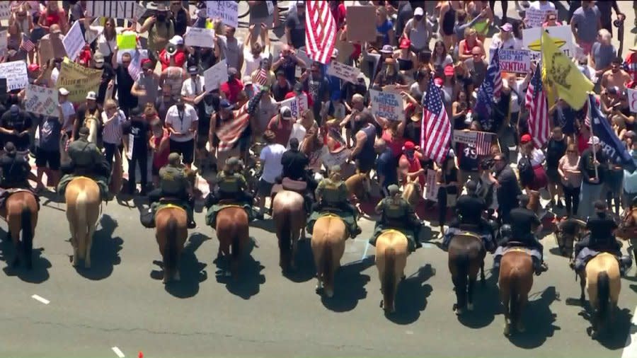 Law enforcement officials in Huntington Beach could be seen herding protestors out of the street during a protest against stay-at-home orders on May 1, 2020.