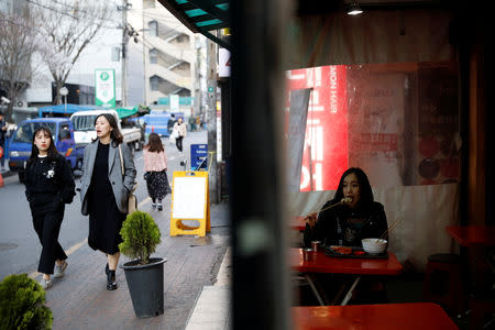 Japanese Yuuka Hasumi, 17, who wants to become a K-pop star, eats 'Tteok-bokki' after class, in the Hongdae area of Seoul, South Korea, April 3, 2019. REUTERS/Kim Hong-Ji