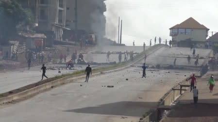 Protesters set up barricades with tyres on a main road in Sonfonia District in Conakry