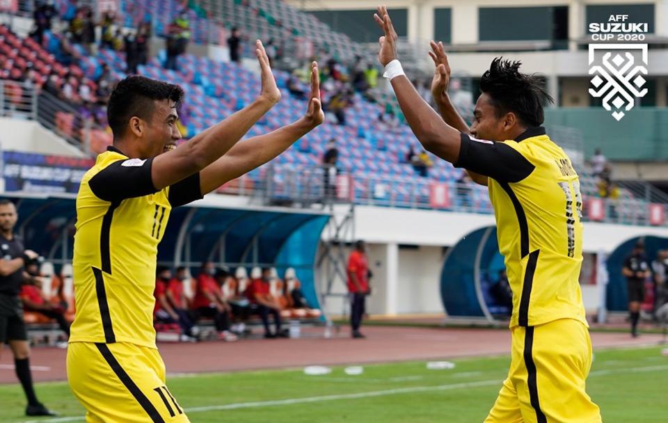 Malaysia's hat-trick hero Safawi Rasid (left) celebrates with his teammate after scoring during their AFF Suzuki Cup match against Laos. (PHOTO: AFF Suzuki Cup)