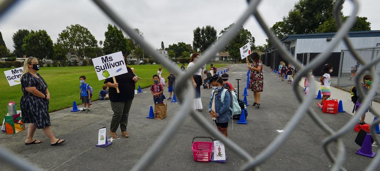 <span class="caption">Teachers organize their socially distanced students at Weaver Elementary School in Rossmoor, California.</span> <span class="attribution"><a class="link " href="https://www.gettyimages.com/detail/news-photo/kindergarten-and-tk-teachers-organize-their-students-on-the-news-photo/1271437757" rel="nofollow noopener" target="_blank" data-ylk="slk:Jeff Gritchen/MediaNews Group/Orange County Register via Getty Images;elm:context_link;itc:0;sec:content-canvas">Jeff Gritchen/MediaNews Group/Orange County Register via Getty Images</a></span>