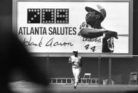 A new sign showing the number of Hank Aaron's home runs provides a background as he runs off the field after the eighth inning of the first game of the doubleheader with the Cincinnati Reds at Atlanta Stadium, Sept. 10, 1973. (AP Photo)