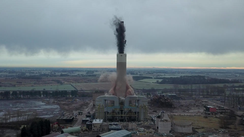 Dozens of spectators gathered to watch the dramatic moment a 183-metre (600ft) tall iconic power station chimney was demolished in a controlled explosion. The imposing concrete tower at Rugeley Power Station collapsed in just four seconds in a cloud of dust. Between 50 and 100 residents gathered on a nearby hillside to watch the spectacle unfold despite police warning people to avoid travelling to the area during lockdown. The massive chimney was demolished using explosive charges to pave the way for new development in the area - including hundreds of homes, a school and offices.