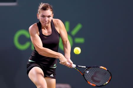 Simona Halep hits a backhand against Sloane Stephens (not pictured) on day ten of the Miami Open at Crandon Park Tennis Center. Halep won 6-1, 7-5. Mandatory Credit: Geoff Burke-USA TODAY Sports