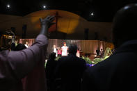 Jan Porter, center, facing stage, and other parishioners at the Cornerstone Baptist Church in Arlington, Texas, sing and celebrate during a morning service on Sunday, Oct. 24, 2021. Porter, a former church elder, says the church and its mission work in the community have benefitted greatly from "substantial" royalties from a natural gas well site on church property, which is now operated by TEP Barnett, an affiliate of French energy giant Total Energies. "It's enabled us to do ministries that we might not have been able to do," he said. Among other things, he said the gas royalties have helped support food giveaways and enabled the church to support other congregations. (AP Photo/Martha Irvine)