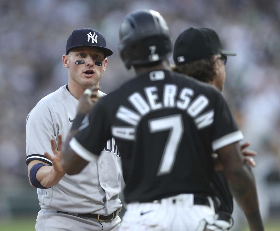 New York Yankees third baseman Josh Donaldson, left, and Chicago White Sox baserunner Tim Anderson (7) exchange words in the first inning on May 13, 2022, at Guaranteed Rate Field in Chicago.