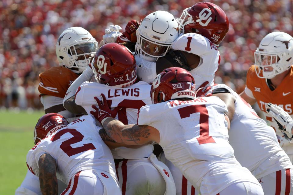 Texas running back Jonathon Brooks is stopped by a group of Oklahoma tacklers including defensive back Billy Bowman Jr. and linebackers Kip Lewis, Jaren Kanak and Dasan McCullough during last year's Red River Rivalry game at the Cotton Bowl.