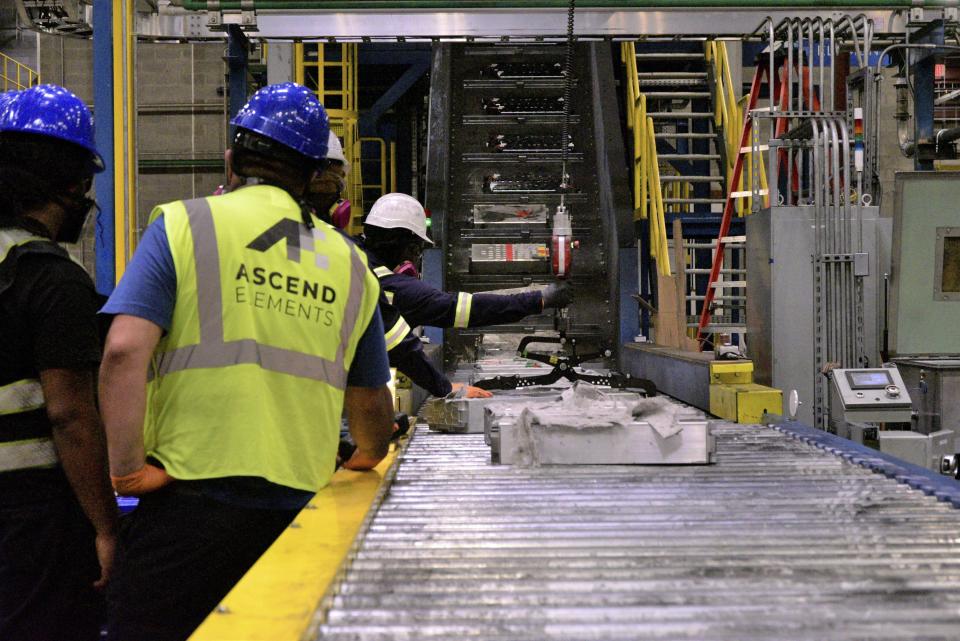 This undated photo provided by Ascend Elements shows team members loading used electric vehicle battery modules onto a massive shredder at the Ascend Elements battery recycling facility in Covington, Ga. A recycling facility will be built in Hopkinsville, Ky., to shred electric vehicle batteries in a $65 million venture between American and South Korean companies — Ascend Elements and SK ecoplant, respectively — that will supply material for a separate battery-related operation in the same town, the companies announced Tuesday, Sept. 26, 2023. (Ascend Elements via AP)