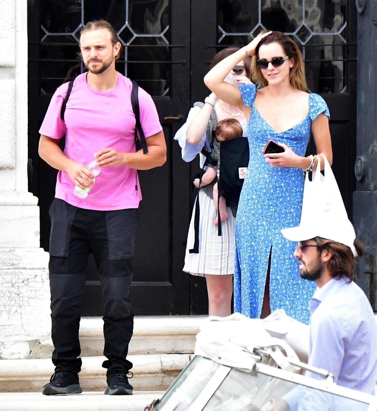 *EXCLUSIVE* 'Harry Potter, actress Emma Watson is pictured looking summery in a blue dress while pictured with Philip Green's son Brandon Green leaving the “Fondazione Prada” in Venice.