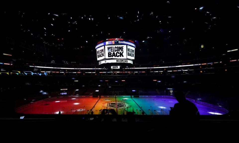 The ice is lit in rainbow light for Pride night before an NHL game between the Anaheim Ducks and the Los Angeles Kings in 2021.