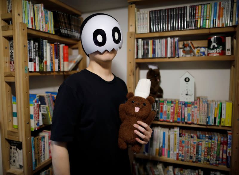 Japanese manga artist Kamentotsu poses for a photograph at his workspace in Tokyo