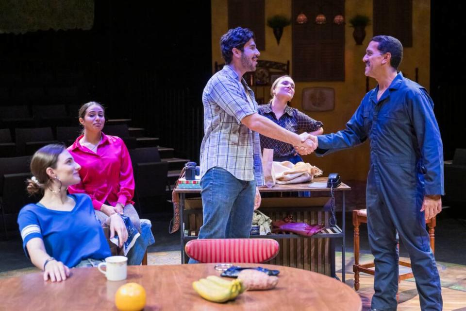 From left, Emily Garcia Carrerou, Analisa Velez and Talita Real look on as Mario Silva and Armando Acevedo greet each other with a handshake in “La Gringa.”