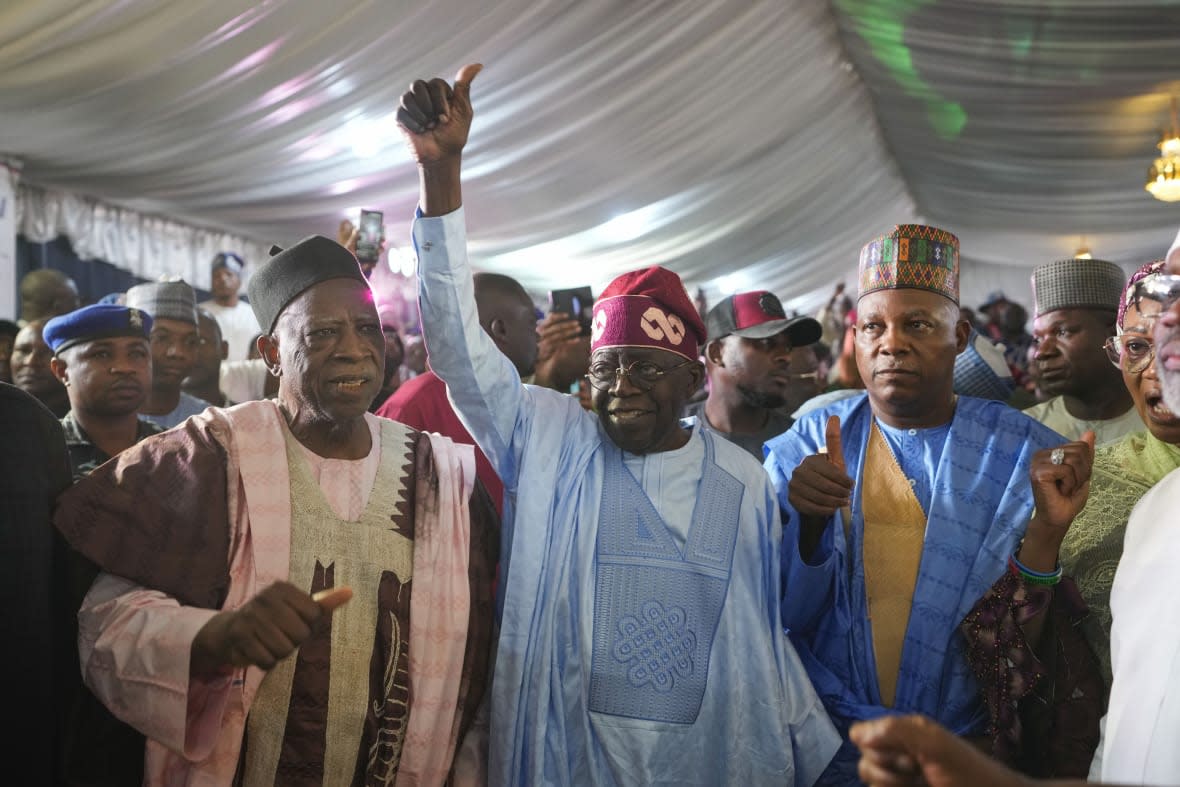 Bola Tinubu of the All Progressives Congress, center, celebrates with supporters at the party’s campaign headquarters after winning the presidential elections in Abuja, Nigeria, Wednesday, March 1, 2023. (AP Photo/Ben Curtis)