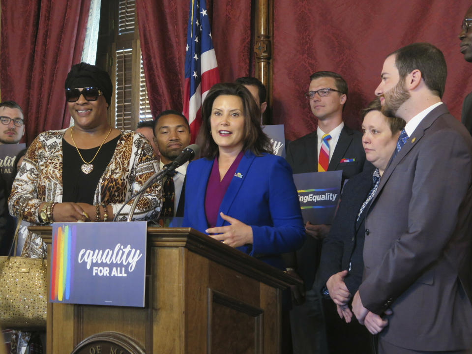 FILE - In this Tuesday, June 4, 2019, file photo, Michigan Gov. Gretchen Whitmer, center, joins with lawmakers and others calling for expanding the state's civil rights law to prohibit discrimination against LGBT people, in the Capitol building in Lansing, Mich. A group launched a 2020 ballot initiative Tuesday, Jan. 7, 2020, to expand Michigan's civil rights law to include anti-discrimination protections for LGBTQ people, a step that would put the issue to voters if the Republican-led Legislature does not pass the measure. (AP Photo/David Eggert, File)