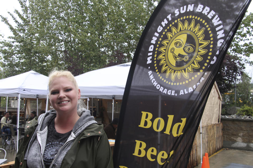 Angelina Backus poses for a photo at the Midnight Sun Brewing Co., Monday, Aug. 24, 2020, in Anchorage, Alaska. Backus, who is a lead server at the brewery, received a $500 tip from Jack Little, and said it helped her pay bills that were piling up during the coronavirus pandemic. (AP Photo/Mark Thiessen)