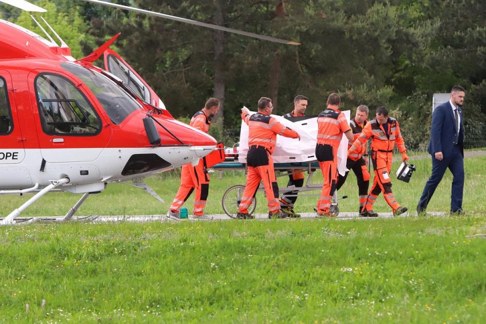 Mr Fico is seen being transported from a helicopter by medics and his security detail to the hospital in Banska Bystrica (AFP via Getty Images)