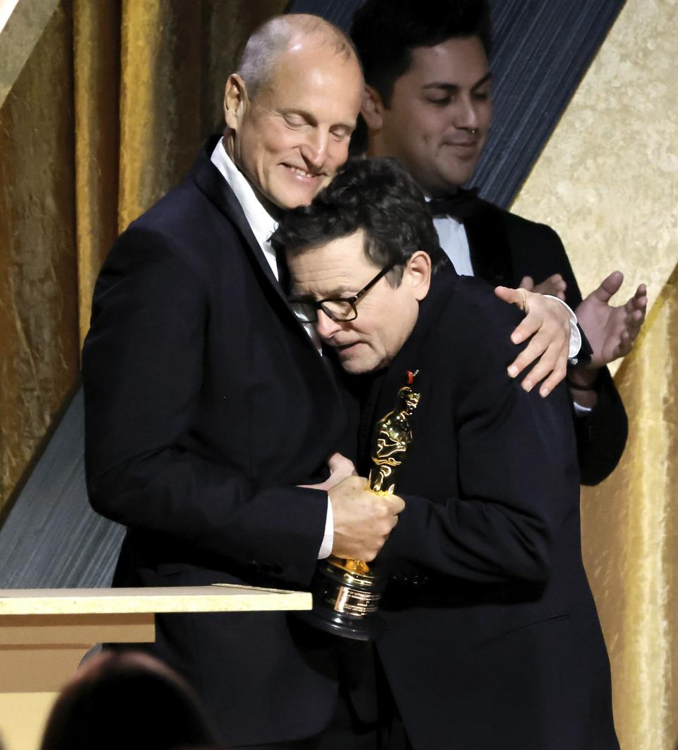 Woody Harrelson congratulates Michael J. Fox, winner of the Jean Hersholt Humanitarian Award, onstage during the Academy of Motion Picture Arts and Sciences 13th Governors Awards at Fairmont Century Plaza on November 19, 2022 in Los Angeles, California