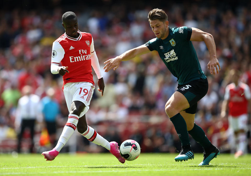 Arsenal's Nicolas Pepe (left) is closed down by Burnley's James Tarkowski during their Premier League match at Emirates Stadium.