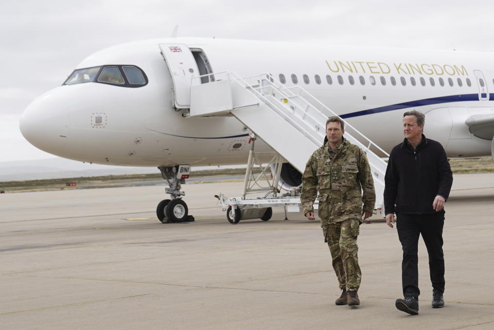 Foreign Secretary Lord David Cameron, right, arrives at Mount Pleasant airbase on the Falkland Islands, during his high-profile visit to demonstrate they are a "valued part of the British family" amid renewed Argentinian calls for talks on their future, in Stanley, Falkland Islands, Britain, on Monday Feb. 19, 2024. (Stefan Rousseau/PA via AP)