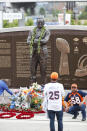 Fans gather for photographs at the foot of a statue during a five-hour memorial for Denver Broncos owner Pat Bowlen Tuesday, June 18, 2019 in at Mile High Stadium, the NFL football team's home in Denver. Bowlen, who has owned the franchise for more than three decades, died last Thursday. (AP Photo/David Zalubowski)