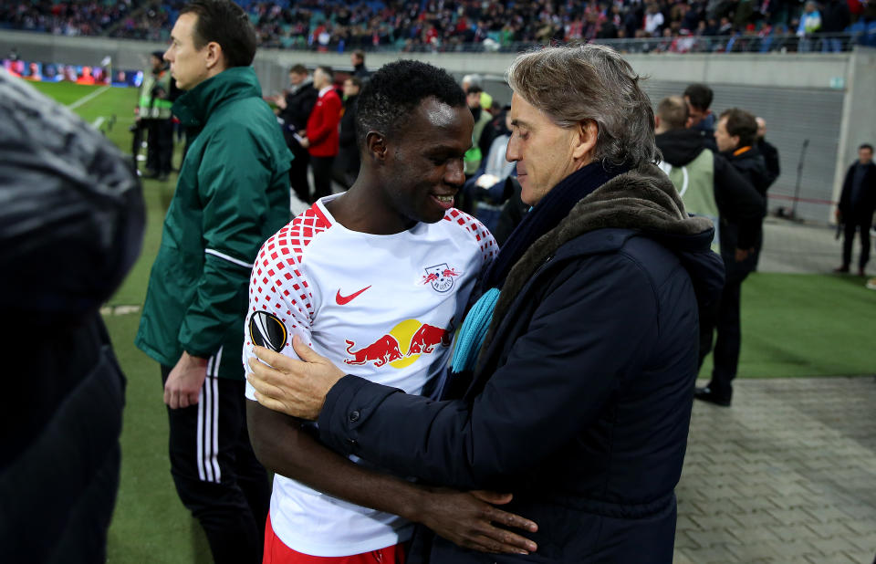 RB Leipzig scorer Bruma embraces Zenit coach Roberto Mancini before the encounter