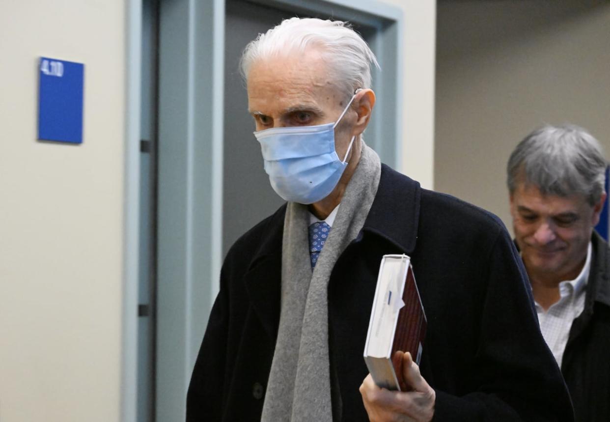 Former Quebec Court of Appeal judge Jacques Delisle, walks to the courtroom at the courthouse in Quebec City, Thursday, March 14, 2024 as his son, Jean Delisle, right, follows.  (Jacques Boissinot/The Canadian Press - image credit)
