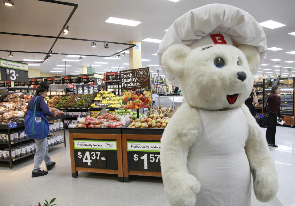 Bimbo Bakeries USA's  Bimbo Bear, right, welcomes consumers at the new Walmart Neighborhood Market, opening its 34,000 square foot store in the Chinatown district  of Los Angeles Thursday, Sept. 19, 2013. (AP Photo/Nick Ut)