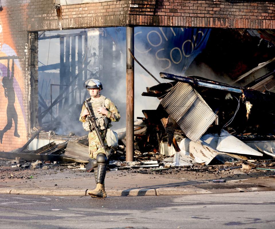 Members of the Minnesota National Guard controlled access to the streets on Lake Street near Columbus Avenue in Minneapolis. Humvees and trucks blocked the road as firefighters and public works officials tried to shut off leaking gas lines and clear rubble from the road. Saturday, May 30, 2020