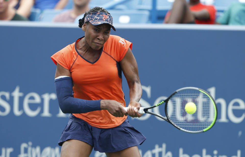 Venus Williams returns a backhand against Lauren Davis during first round play at the Western & Southern Open tennis tournament, Monday, Aug. 12, 2019, in Mason, Ohio. (AP Photo/Gary Landers)