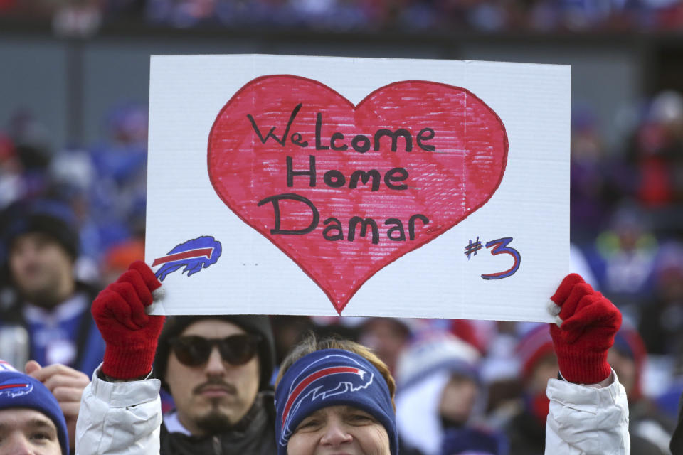 A Buffalo Bills fan holds up a sign in support of Buffalo Bills safety Damar Hamlin (3) prior to an NFL wild-card playoff football game between the Buffalo Bills and the Miami Dolphins, Sunday, Jan. 15, 2023, in Orchard Park, N.Y. (AP Photo/Joshua Bessex)