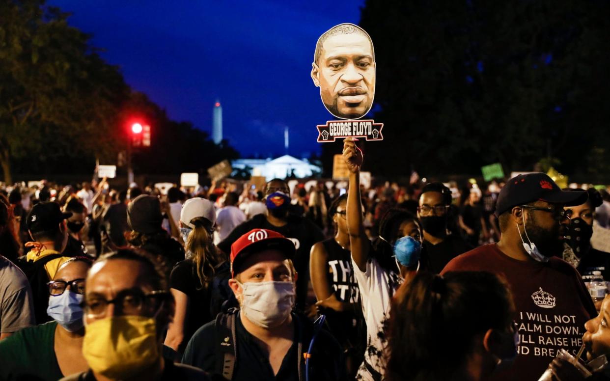 Demonstrators protest on Saturday near the White House in Washington - AP