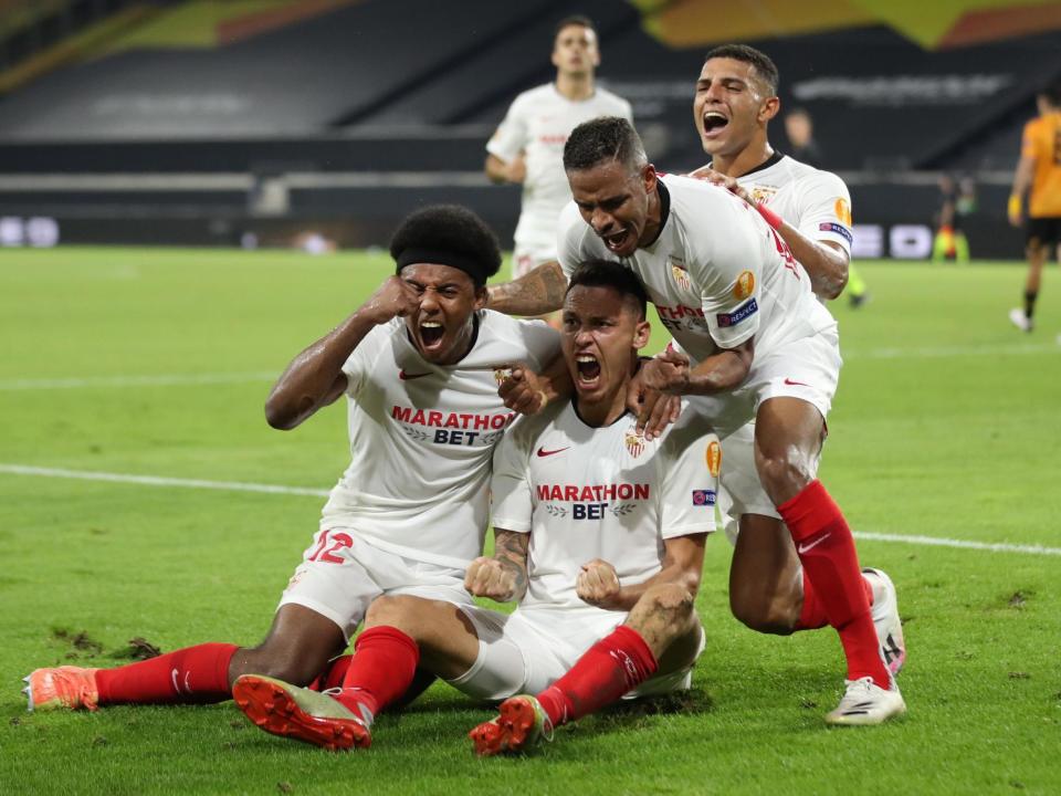 Ocampos and Sevilla celebrate taking lead in Germany: POOL/AFP