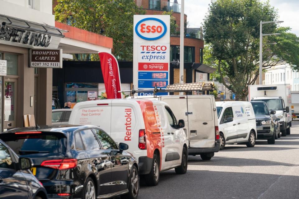 Vehicles queue for fuel at a petrol station in west London (Dominic Lipinski/PA) (PA Wire)