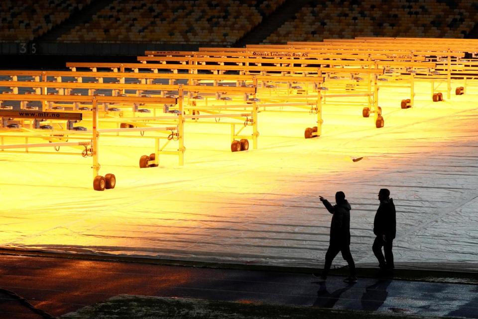 Cover up | Unai Emery inspects the pitch at the Olympic Stadium in Kiev last night: REUTERS/Gleb Garanich