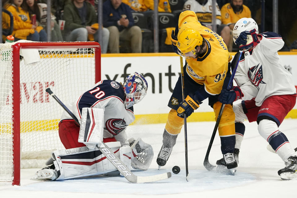 Nashville Predators center Matt Duchene (95) battles with Columbus Blue Jackets goaltender Joonas Korpisalo (70) and defenseman Adam Boqvist (27) in the second period of an NHL hockey game Tuesday, Nov. 30, 2021, in Nashville, Tenn. (AP Photo/Mark Humphrey)