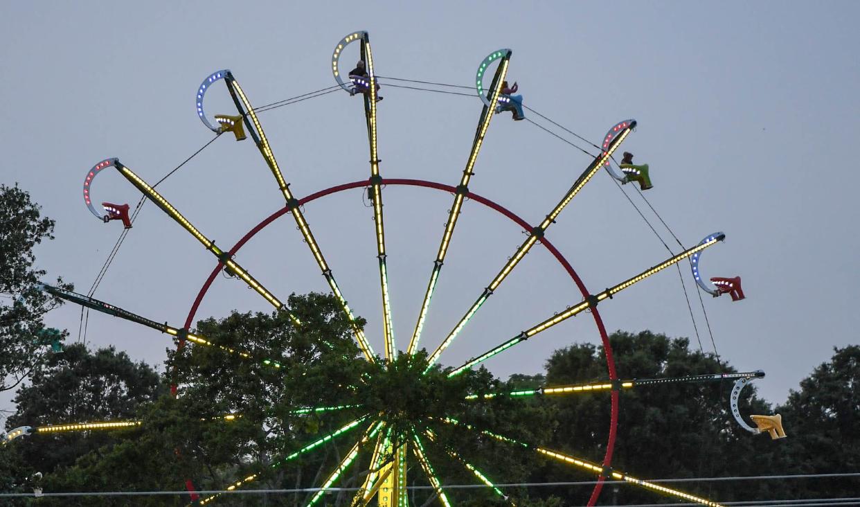 People ride on a Ferris wheel during opening day of The Great Anderson County Fair at the Anderson Sports and Entertainment Center in Anderson Thursday, May 4, 2023. The fair lasts 11 days, through May 14, with rides, shows, exhibits, and food. 